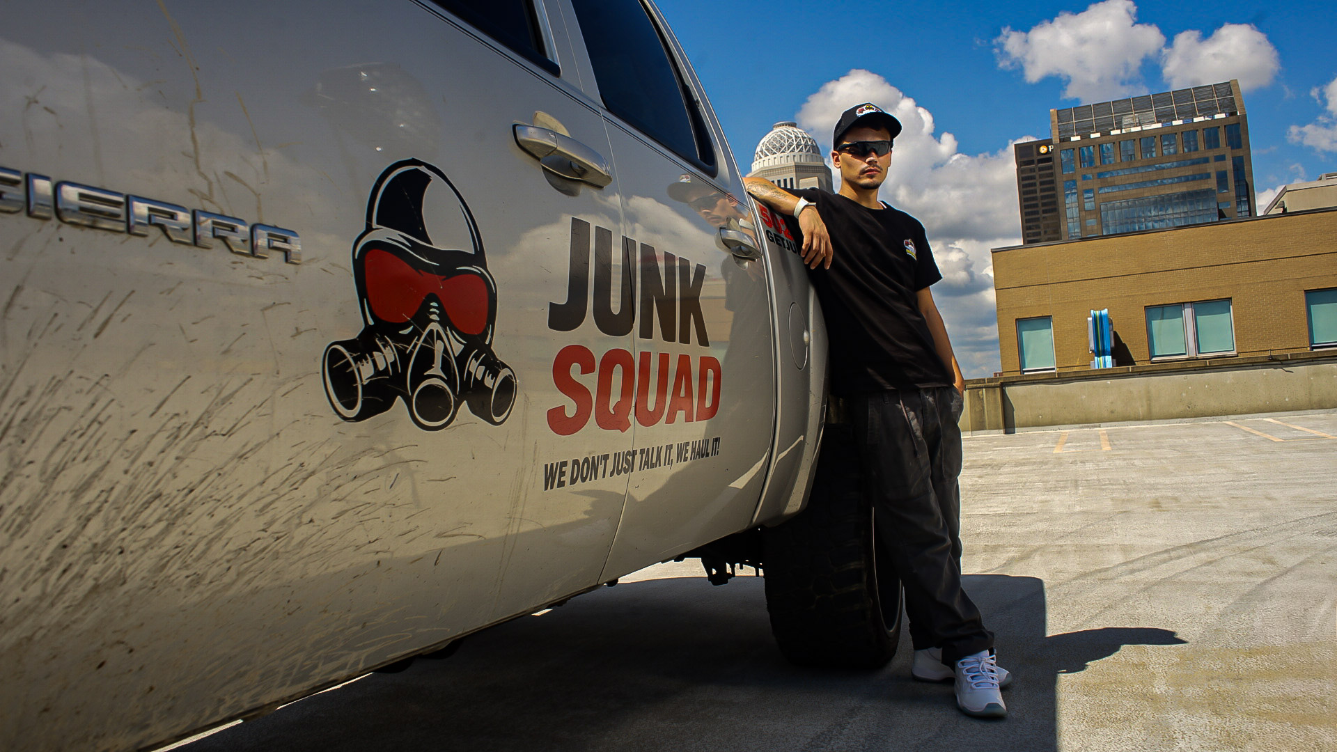 Junk Squad crew member with the company truck in downtown Louisville