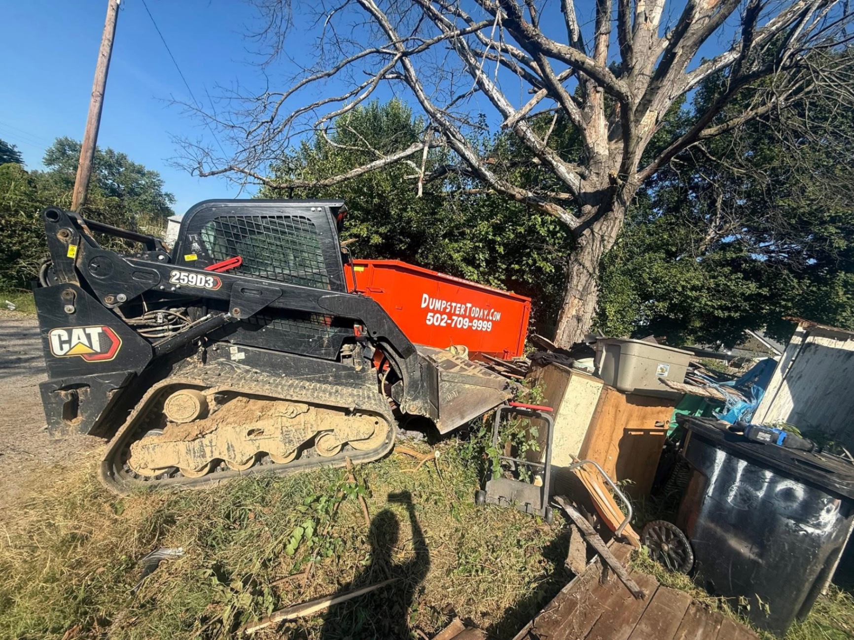 HEAVY EQUIPMENT: CAT skid steer + dumpster combo for the big jobs.